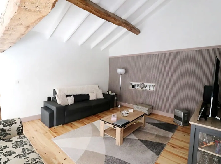 Modern living room with wooden beams and TV