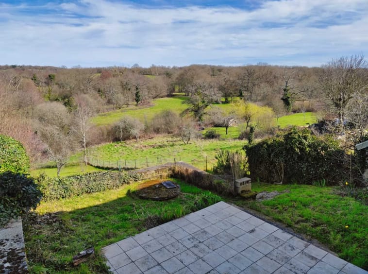 Scenic countryside landscape with trees and grass fields.