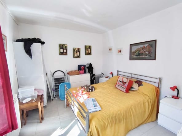 Bright bedroom with yellow bedding and wall art.