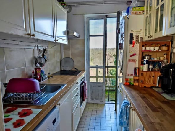 Cosy kitchen with open door to garden view.