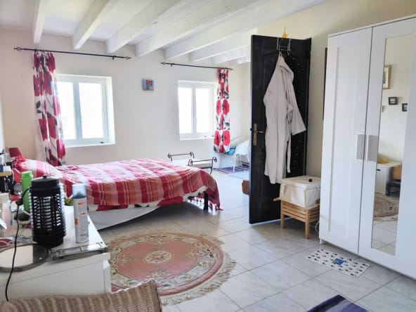 Cosy bedroom with red decor and wardrobe