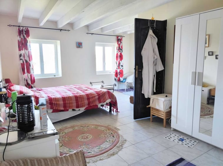 Cosy bedroom with red decor and wardrobe