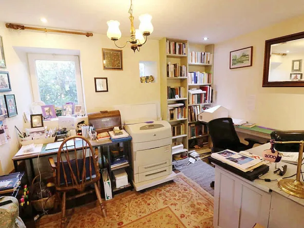 Home office with desk, chair, and bookshelf.