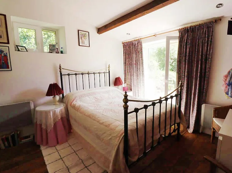 Cosy bedroom with large bed and curtains