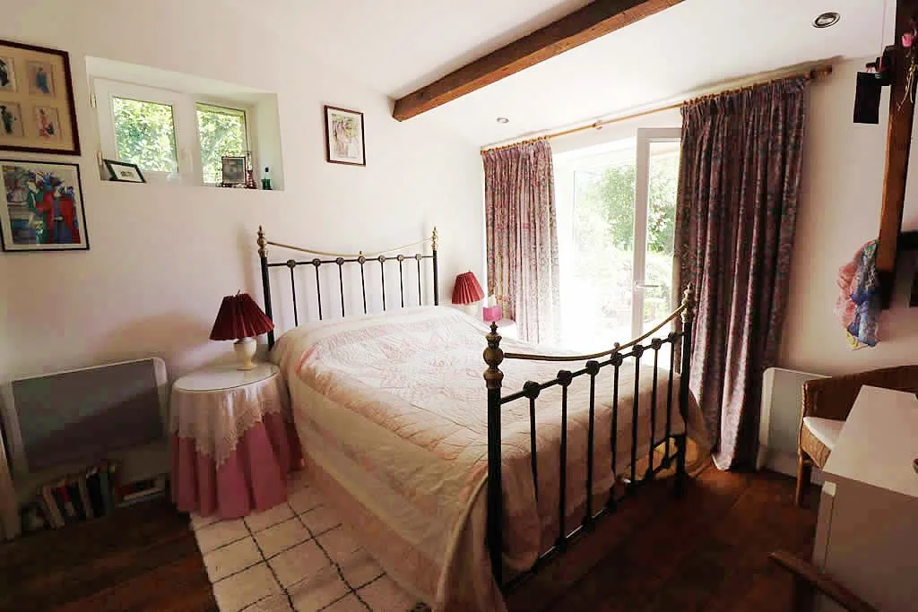 Cosy bedroom with large bed and curtains