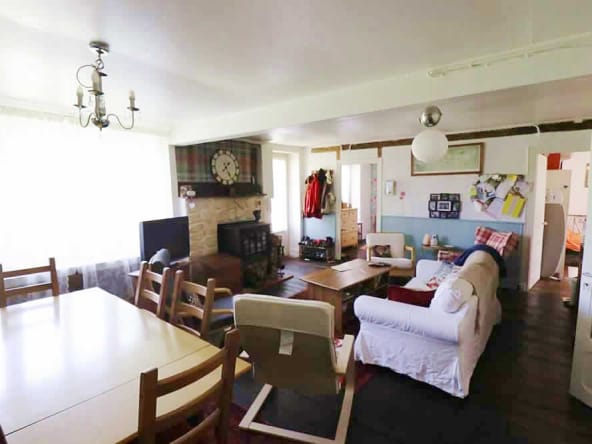 Cosy living room with fireplace and dining area