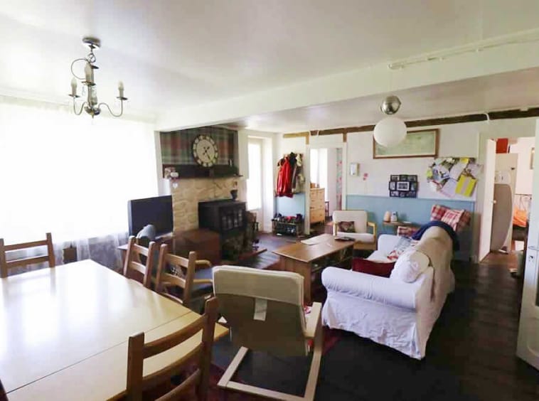 Cosy living room with fireplace and dining area