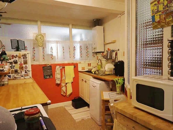Cosy kitchen with wooden countertops and vintage decor.
