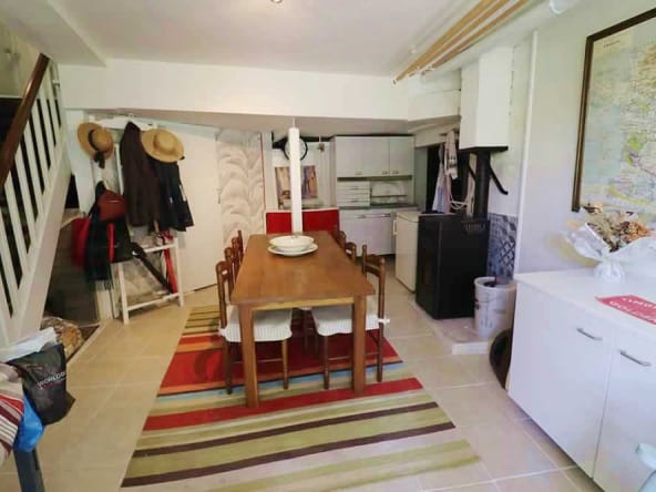 Cosy kitchen with wooden dining table and map.