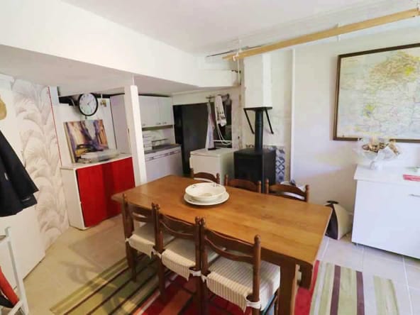 Cosy kitchen with wooden table and map.