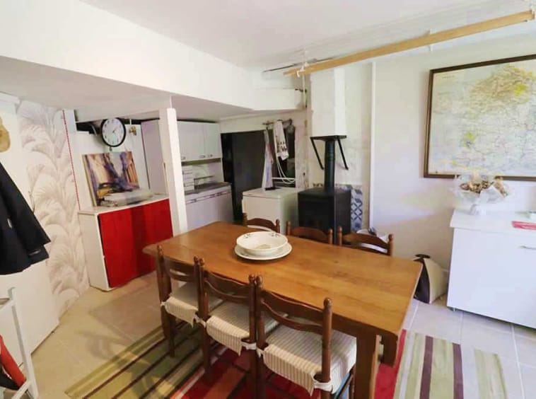 Cosy kitchen with wooden table and map.