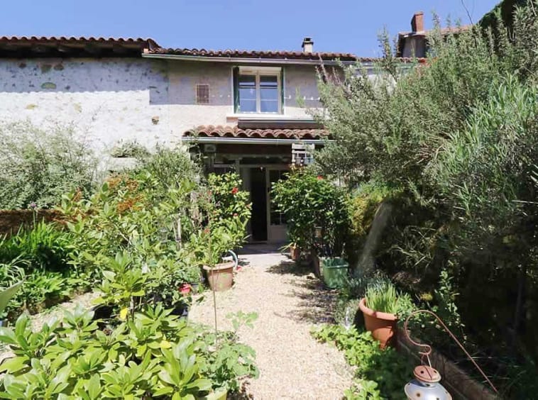 Charming house with lush garden pathway