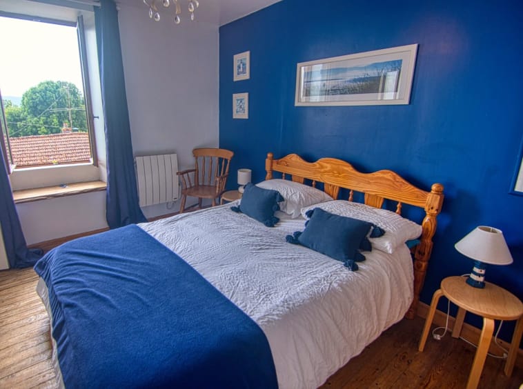 Cosy bedroom with blue and white decor.