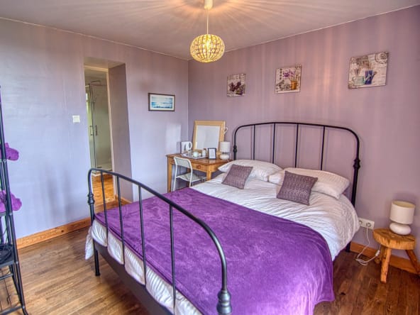 Lavender themed bedroom with a double bed.