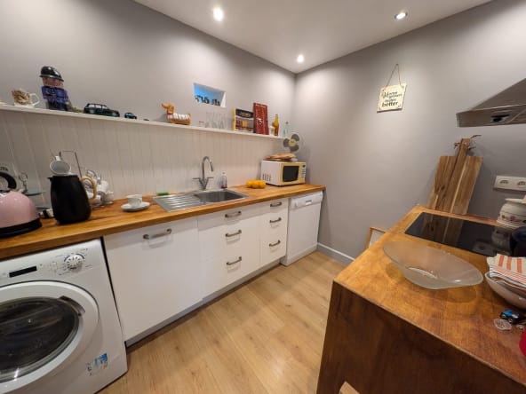 Modern kitchen with wooden countertops and appliances.