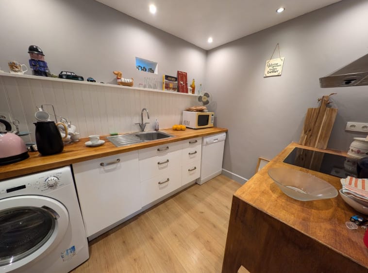 Modern kitchen with wooden countertops and appliances.