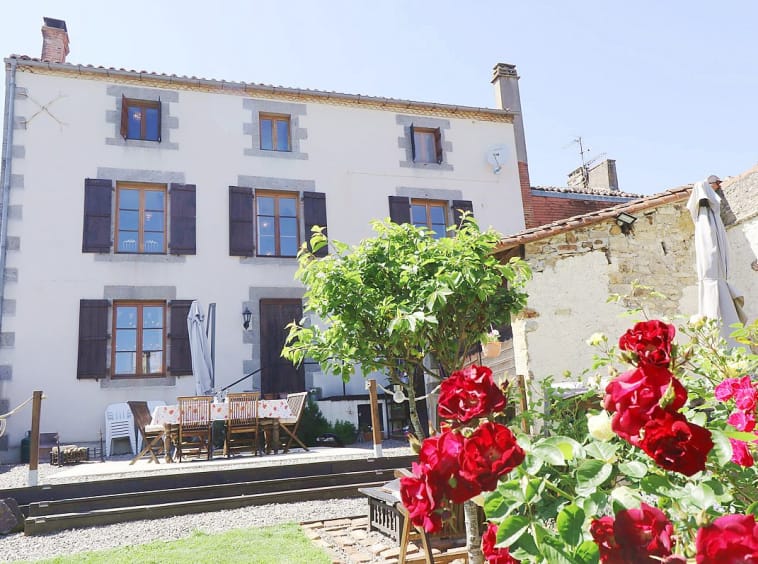 Country house with garden and flowers.