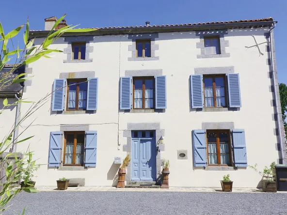 Charming house with blue shutters and door.