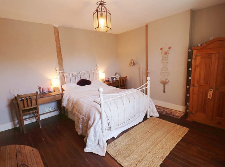 Cozy bedroom with rustic wooden furniture and decor.