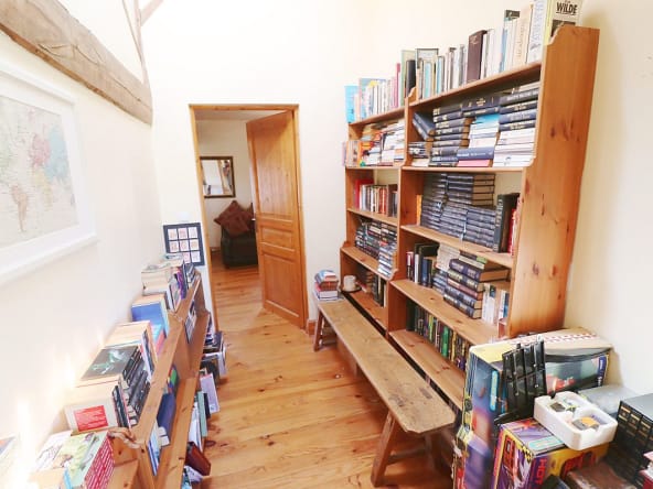 Cosy hallway with bookshelves and a world map.