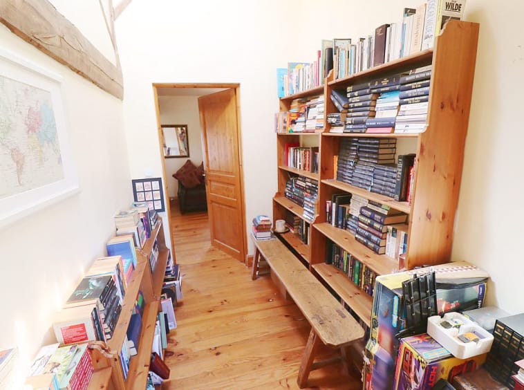 Cosy hallway with bookshelves and a world map.