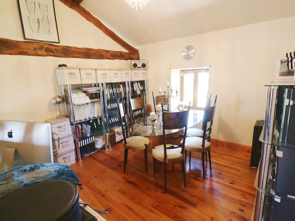 Cosy home office with wooden floors and shelves.