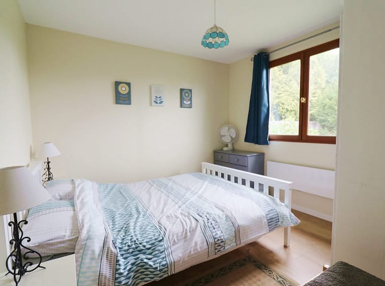 Chambre confortable avec lumière naturelle et décor.