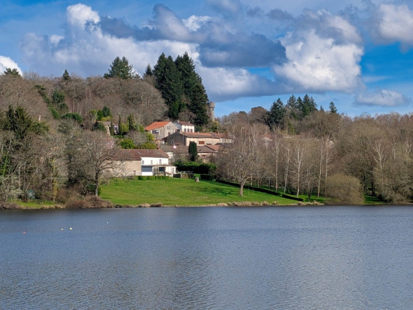 Scenic lake and tree-lined hillside village view