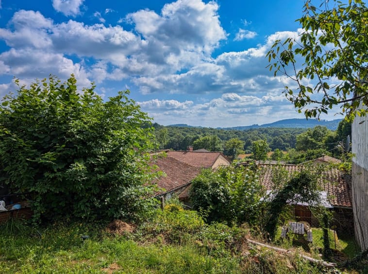 Scenic countryside view with hills and cloudy sky.