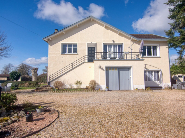 Front view of a two-storey house with garden.