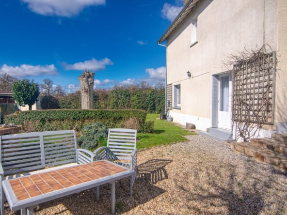 Sunny garden with benches beside a house