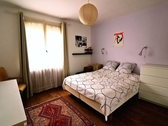 Cosy bedroom with double bed and modern decor.