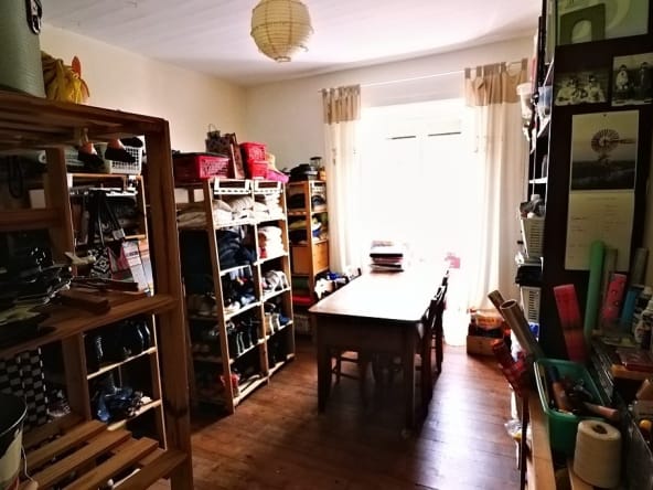 Organised storage room with shelves and table.